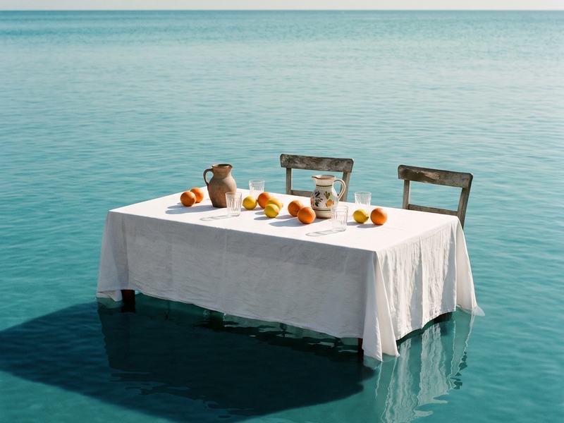 Brunch table on a calm sea, AI dreamscape